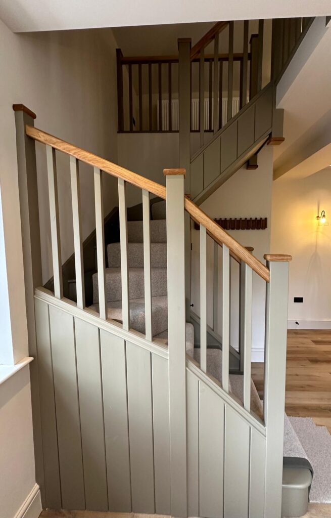 Bespoke timber staircase with panelled balustrade made by Baker Builds